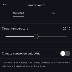 A hand holds a smartphone displaying a climate control app. The screen shows settings like target temperature and economy mode with a green toggle.