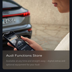 A person holds a smartphone showing the Audi Functions Store app, with options for a Matrix LED Package. A blurred car taillight is visible in the background.