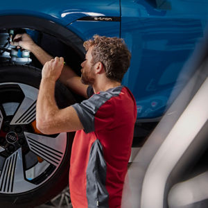 A mechanic checking on the breaks of a car