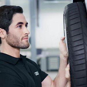 A man changing a car tyre