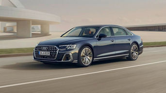 A blue saloon Audi car in motion on the road