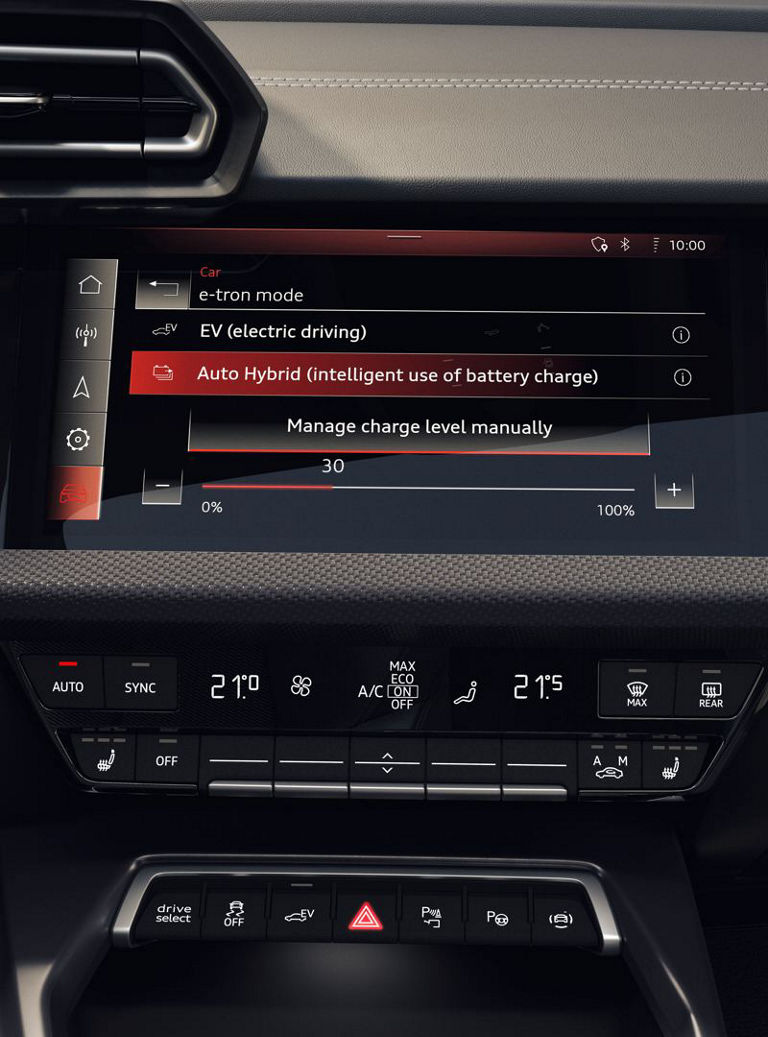 Touchscreen shows hybrid mode and charging settings in the Audi interior.