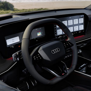 View of the cockpit with focus on the steering wheel with gear selector.