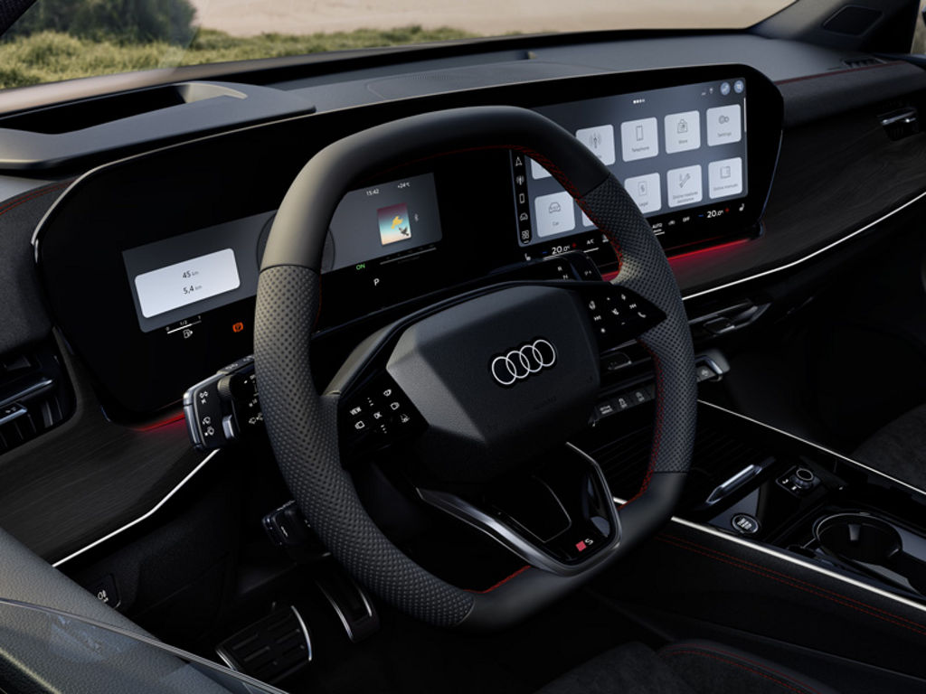 Front view of the steering wheel, center console, and digital displays.