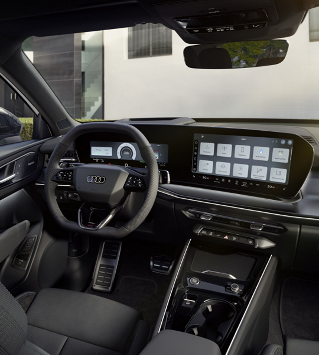The cockpit of the Q3 SUV e-hybrid with a focus on the driver's instrument panel and the panoramic display.	