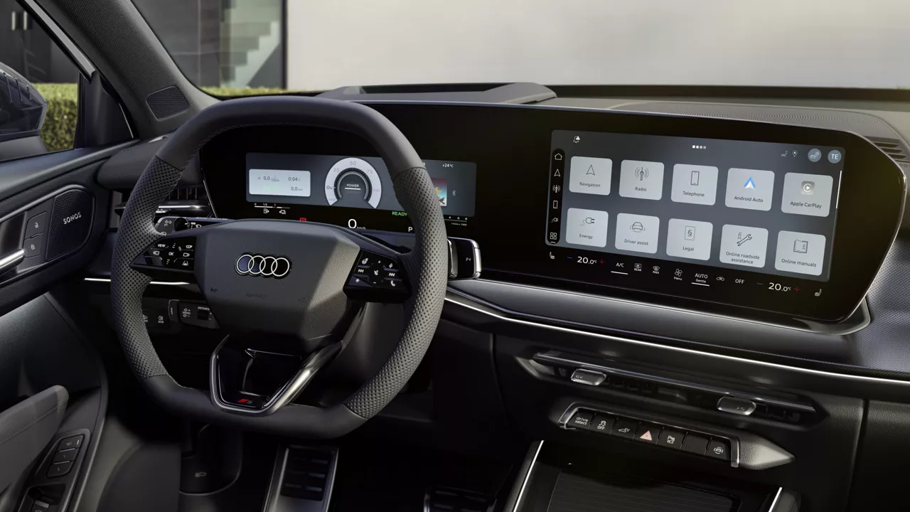 The cockpit of the Q3 SUV e-hybrid with a focus on the driver's instrument panel and the panoramic display.