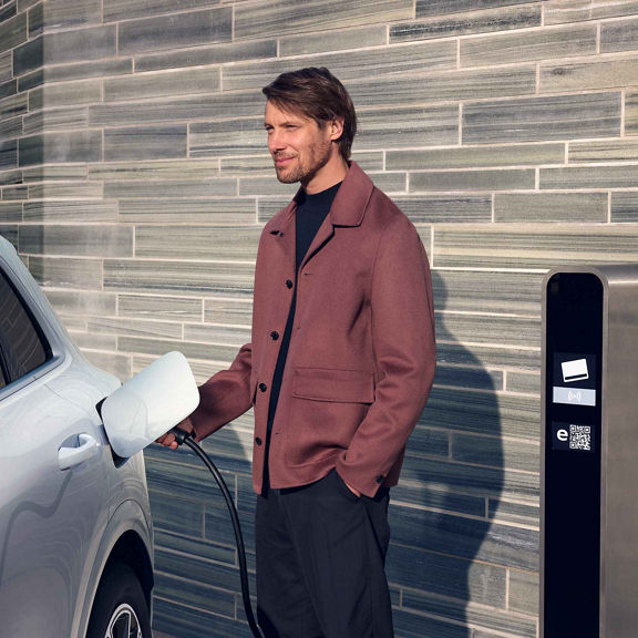 Audi Q5 SUV e-hybrid is charged by a man