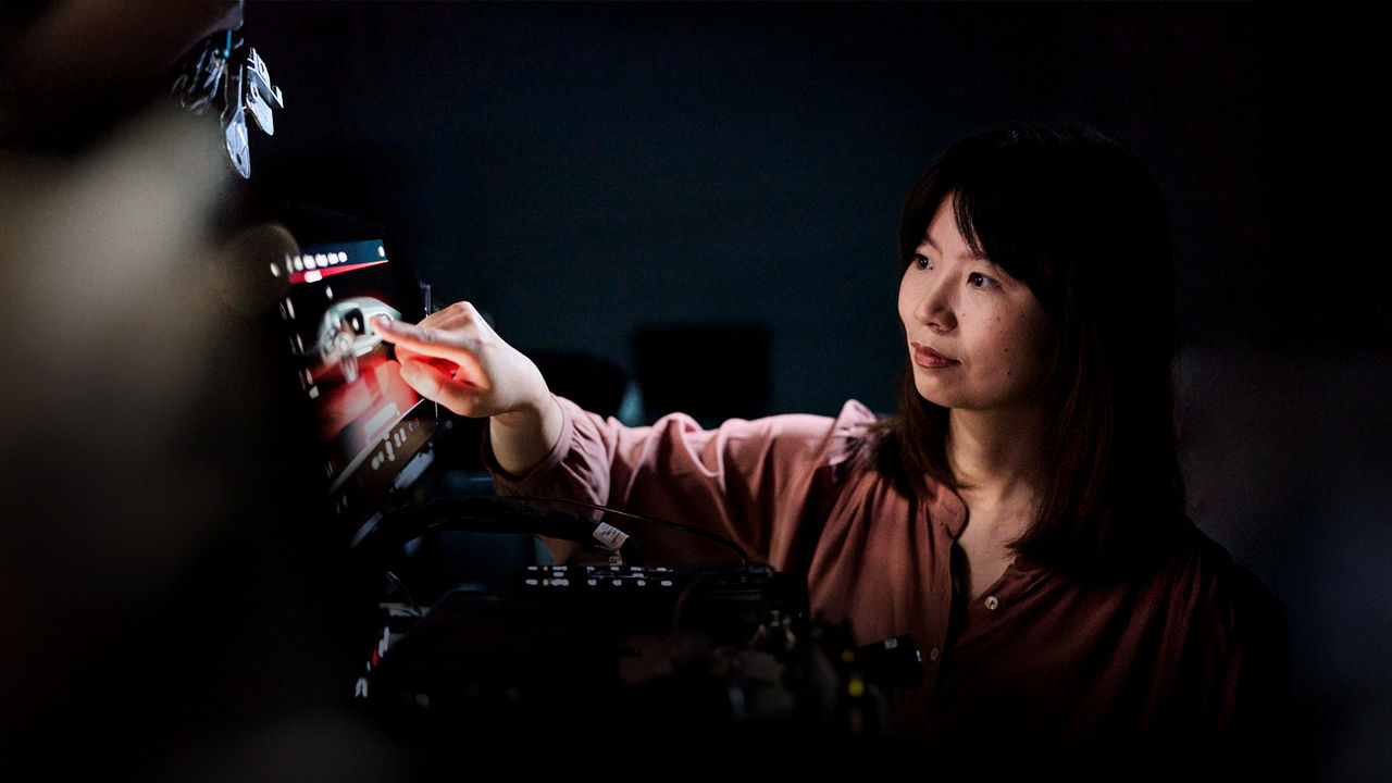 Melanie Schillinger clicks her finger on the screen of a device.