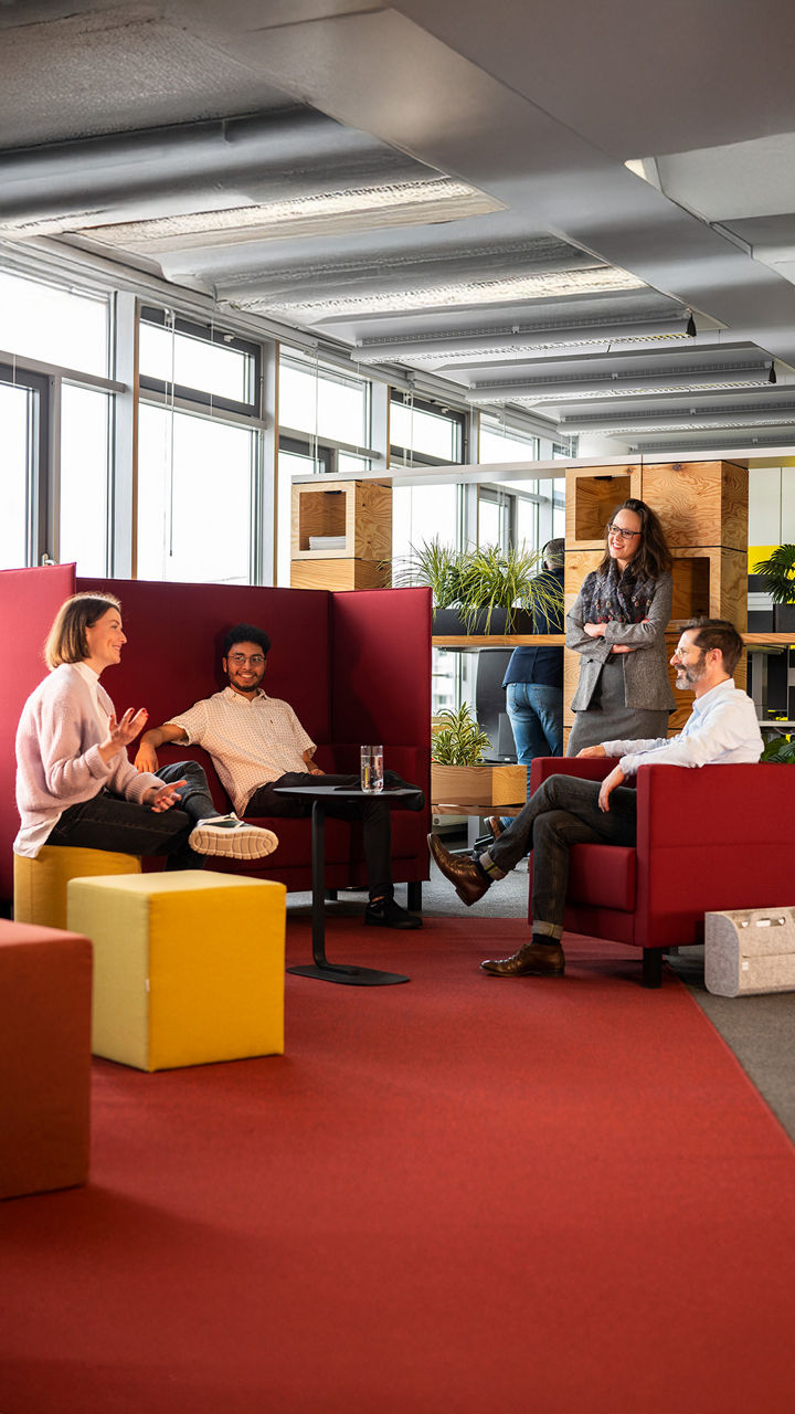 A group of people chatting in a seating area