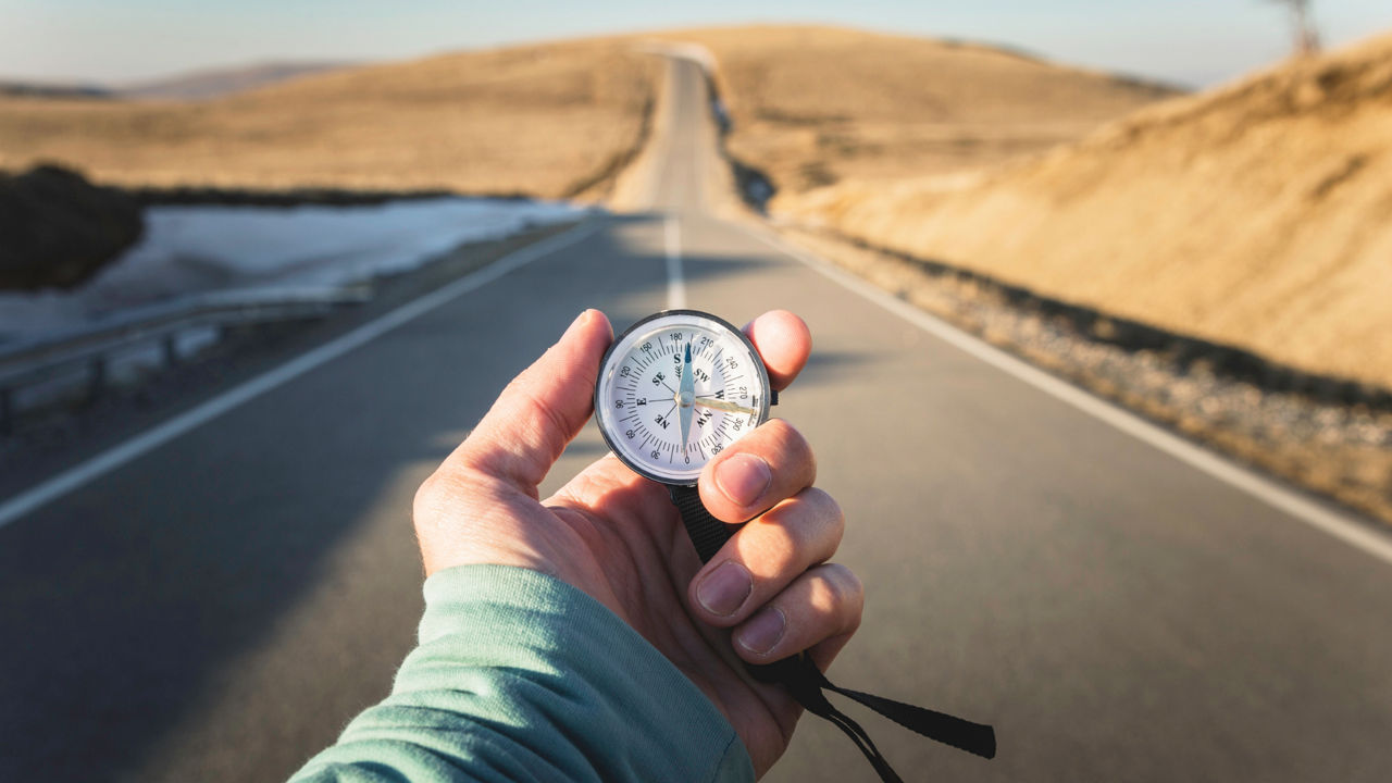 Hand holds compass