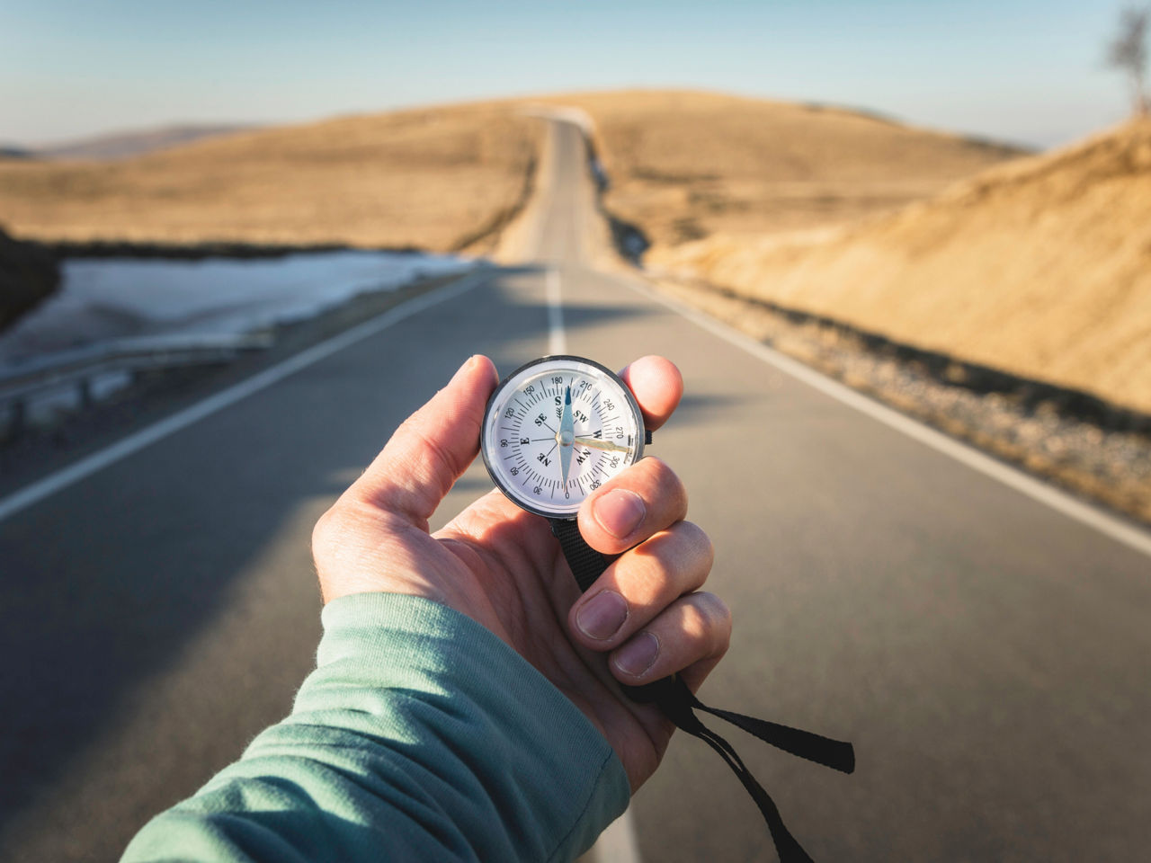 Hand holds compass