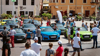 Viele Menschen laufen zwischen ausgestellten Audi Modellen herum