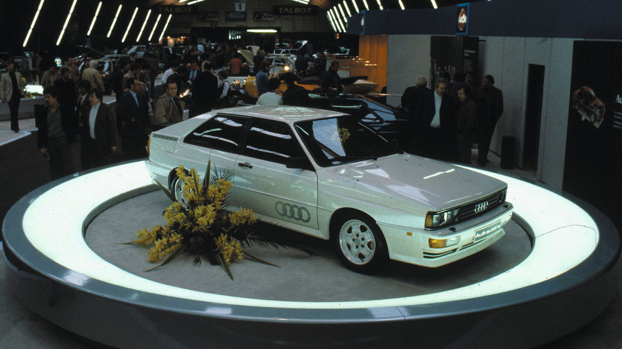 An Audi model is presented on a pedestal at an event