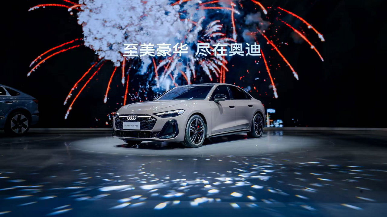 White Audi A5L on stage at Auto Guangzhou with an animation of fireworks in the background