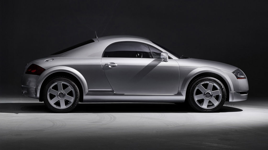 Side view of an Audi TT model against a grey background.