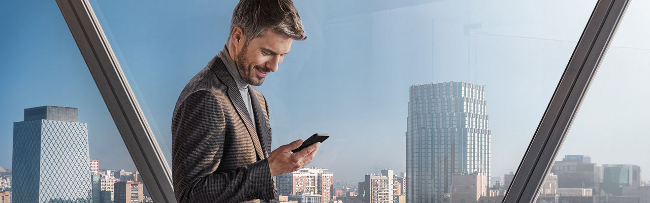 Man looks at his smartphone display