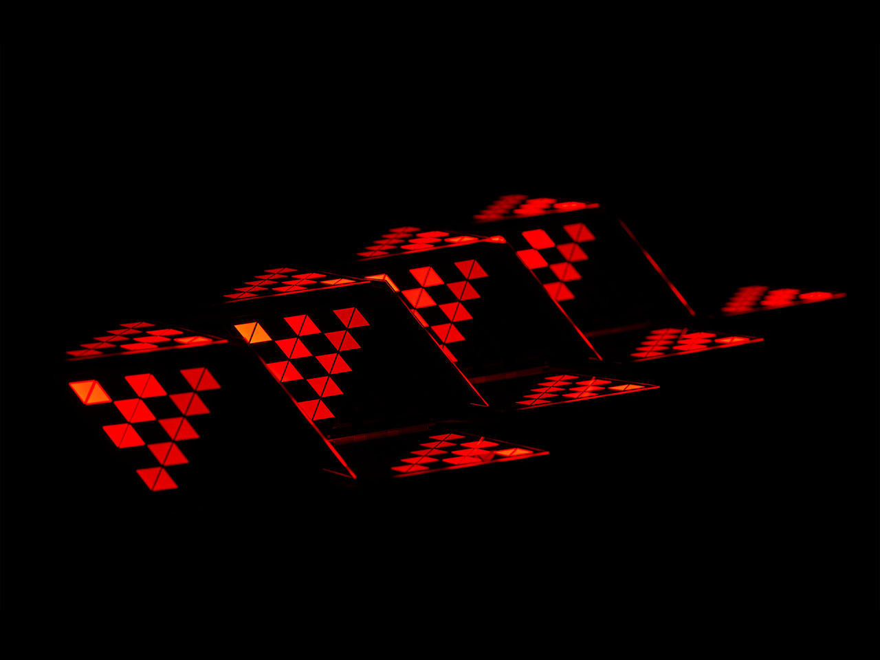 Triangular pattern of LED tail lights on a black background