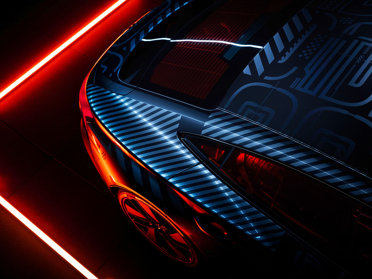 Vehicle rear with stripe foiling, illuminated by colourful neon light