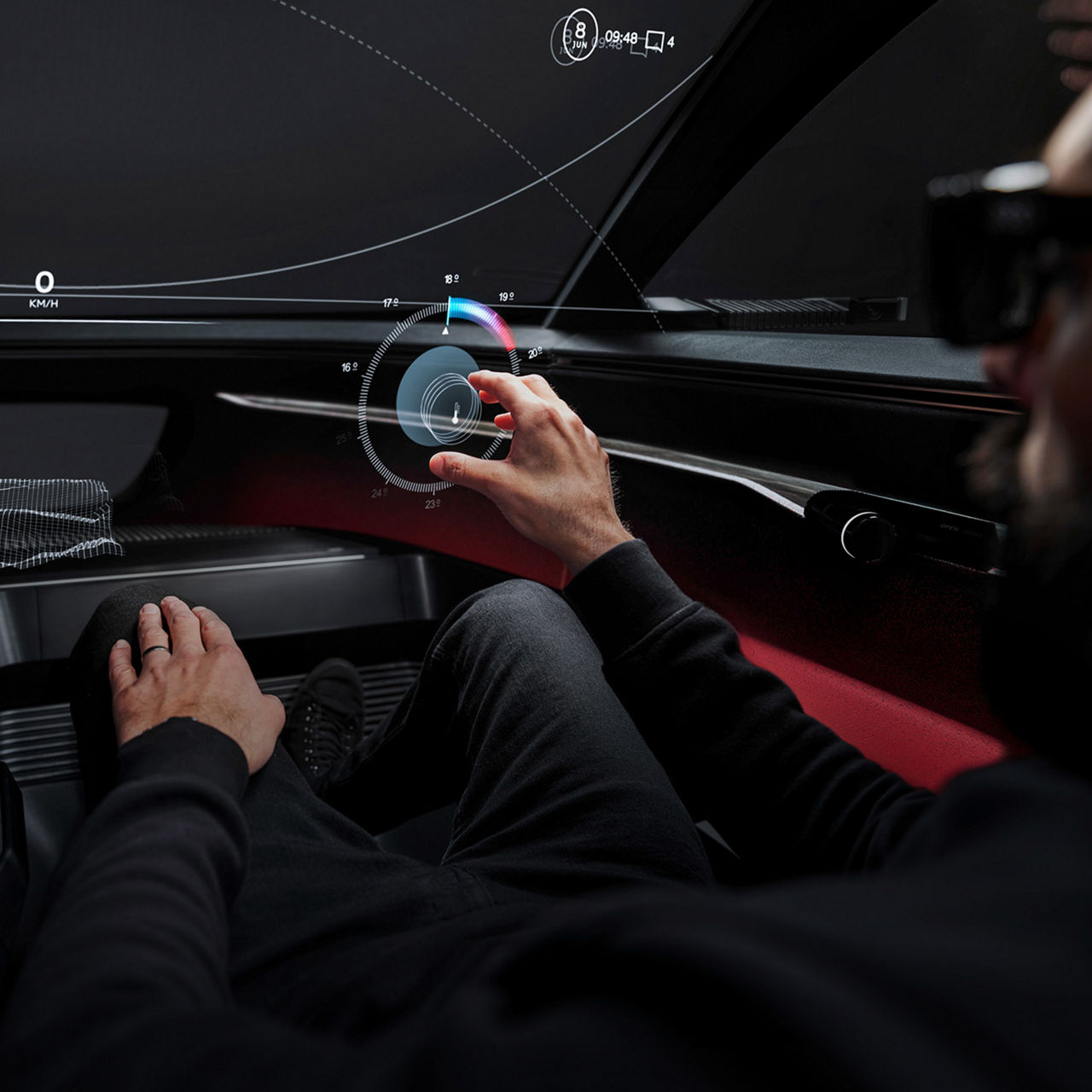 A futuristic vehicle cockpit without physical controls. The driver's hand reaches for a virtual button that floats freely in the air as a hologram.