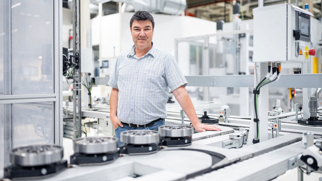 Attila Kovacs stands at a workstation in the workshop
