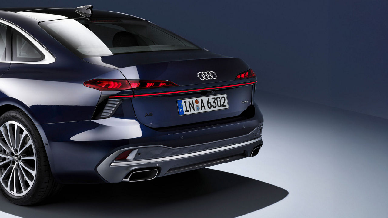 Oblique view of the rear of a black Audi A6 Sedan and its aerodynamic lines.
