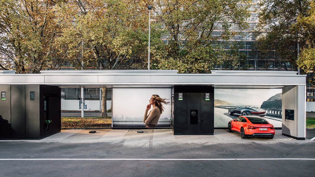 Red Audi e-tron GT quattro charging at the Audi Charging Hub Zurich