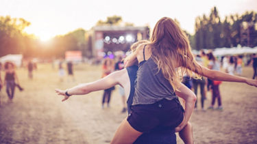 A woman is carried piggyback outside 