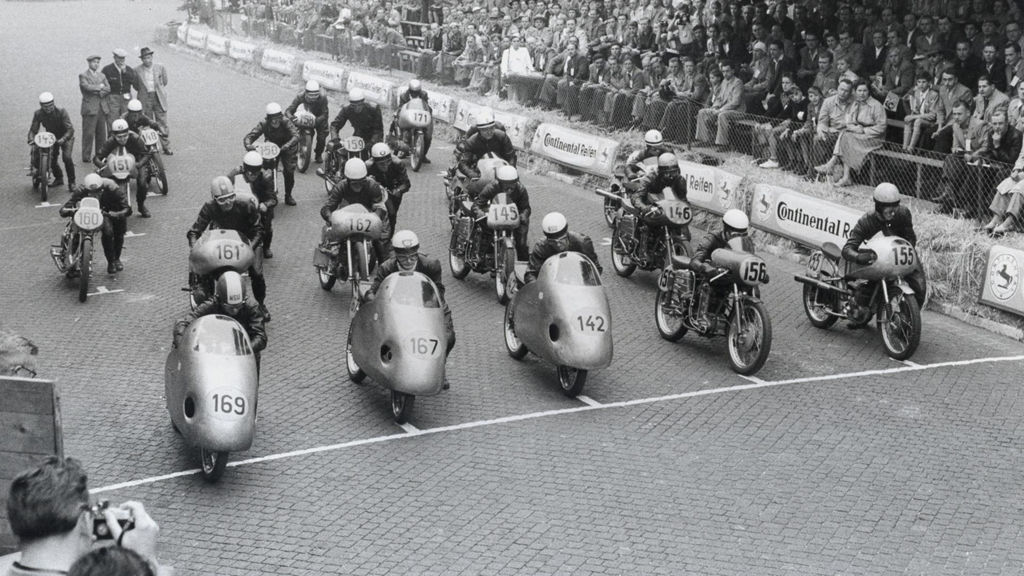 A picture showing the start of a motorcycle race, including NSU motorcycles.