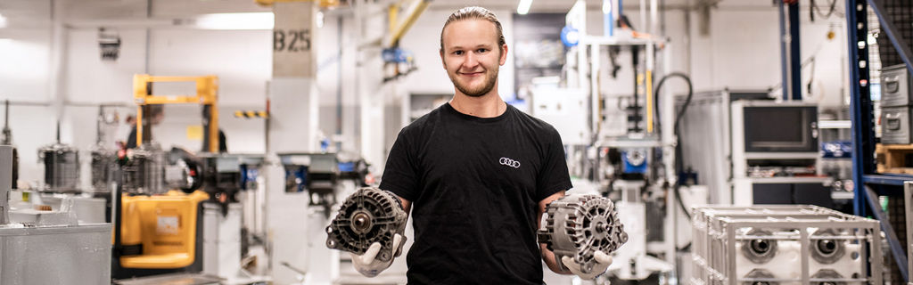 An employee presents two components in production