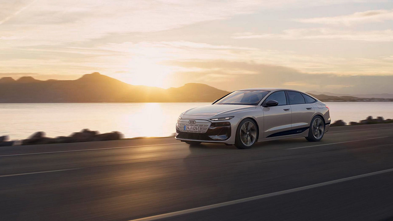 Audi A6 e-tron performance is driving in front of a sunset