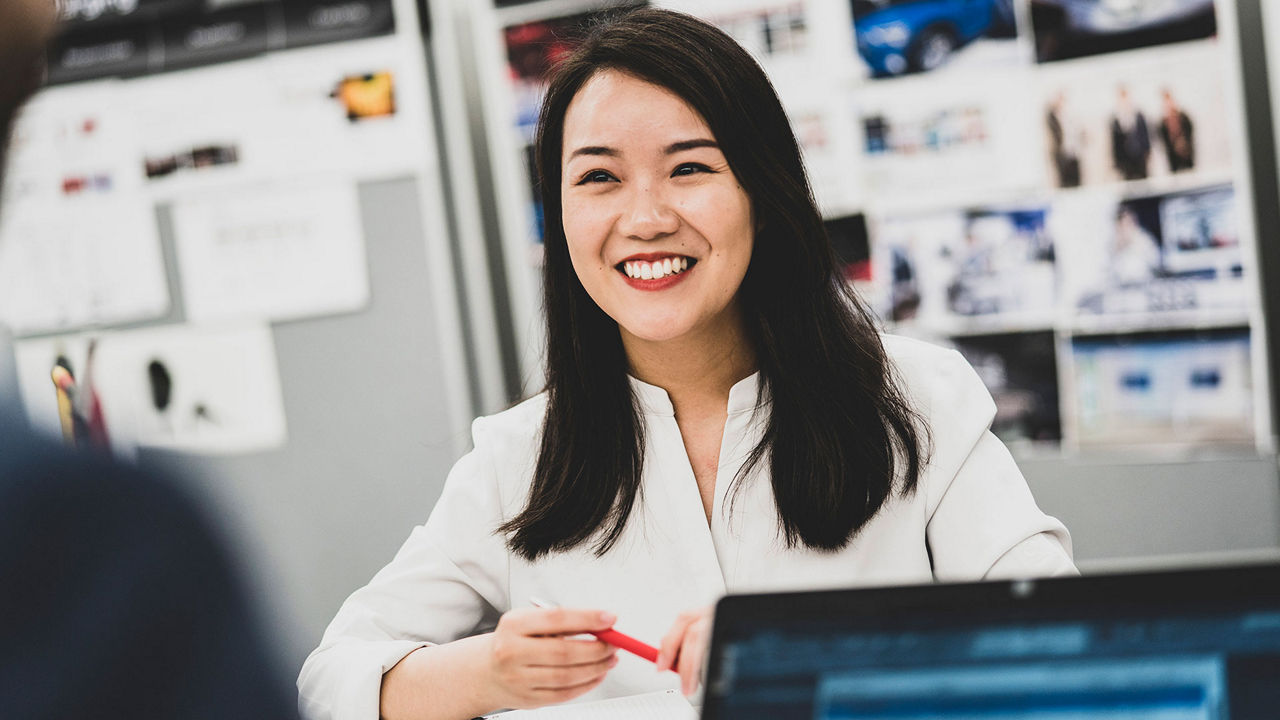 A woman laughs past the camera