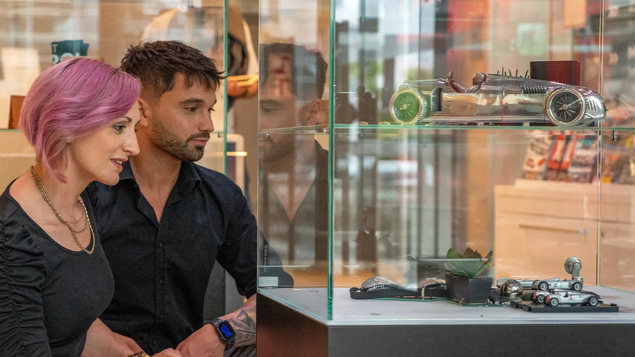 Two people looking at exhibits in the Audi Museum mobile