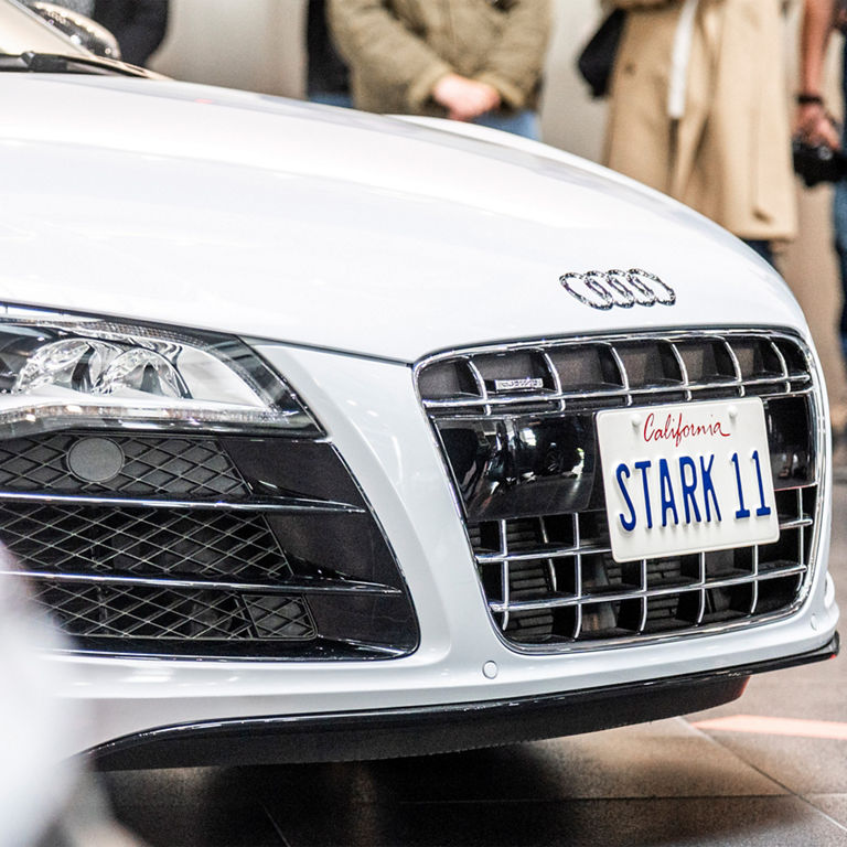Close up of a white Audi with license plate "Stark 11".