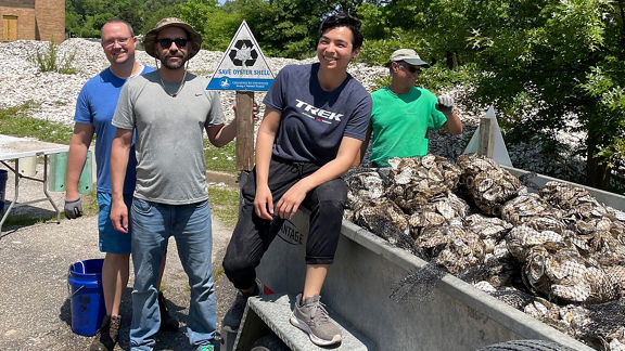 Helfer neben einem beladenen Wagen