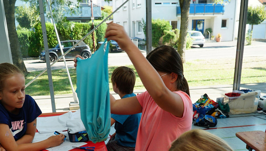 Young girls work with old T-shirts