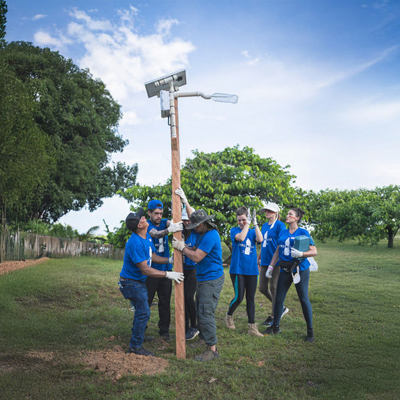Helpers install a new light source.