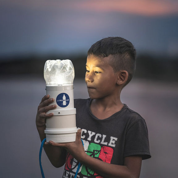 Small boy holding a light source.