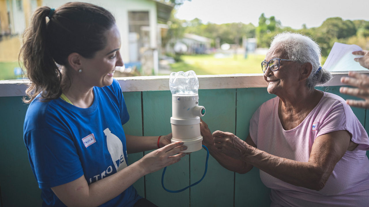 A young and an old woman holding a light source.