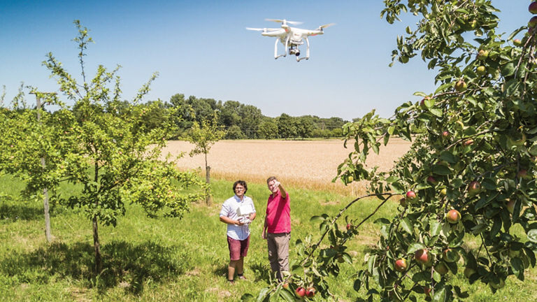 Two people launch a drone