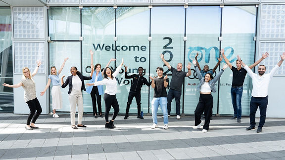 People cheer in front of a building