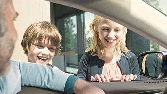 Two children in front of side rear view mirror having fun with their father - Feedback Form