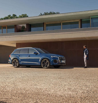 Audi Q7 parked in front of building