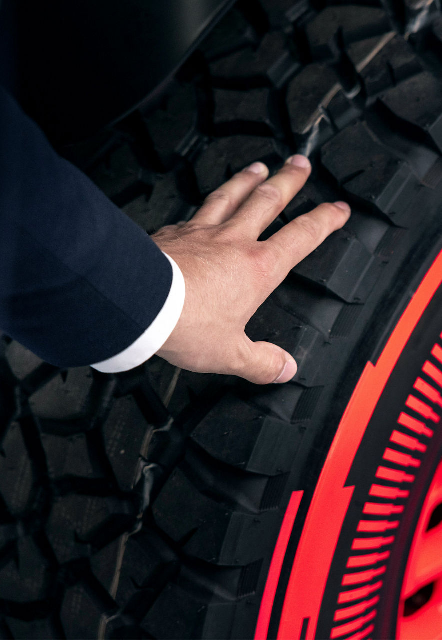 Une main posée sur un pneu de l'Audi RS Q e-tron.