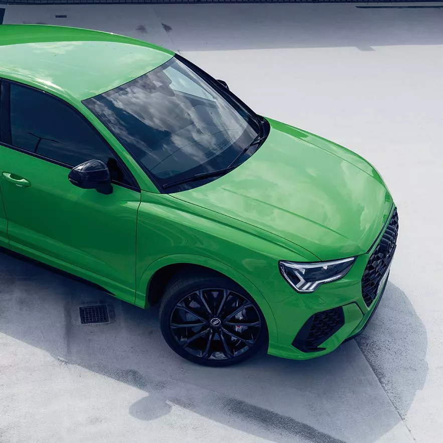 Audi RS Q3 Sportback side front view with a woman