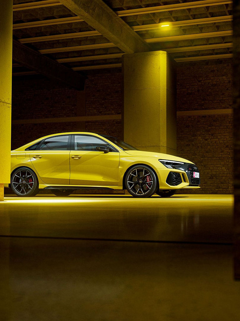 Audi RS 3 sedan side view on the road