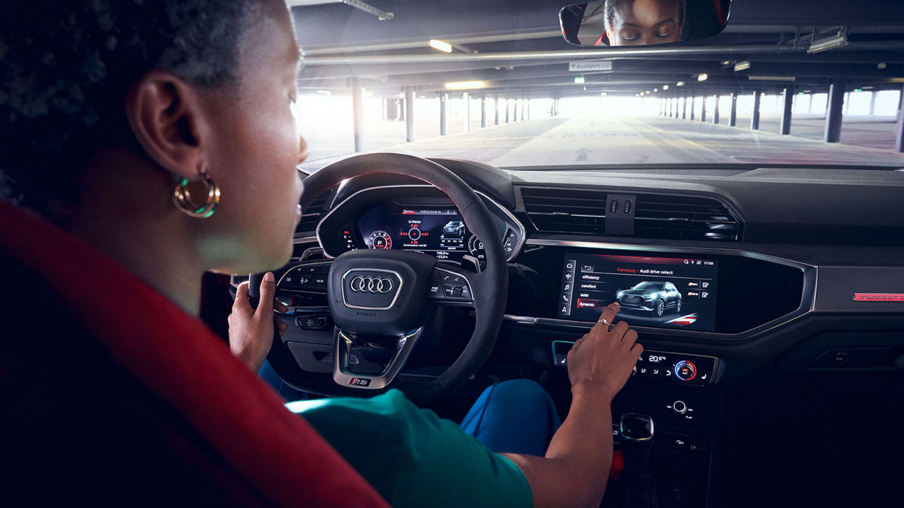 Driver operates the MMI system in the Audi RS Q3