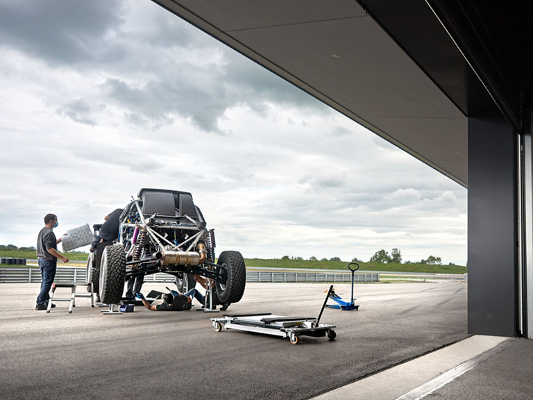 The vehicle is assembled in the open air. 