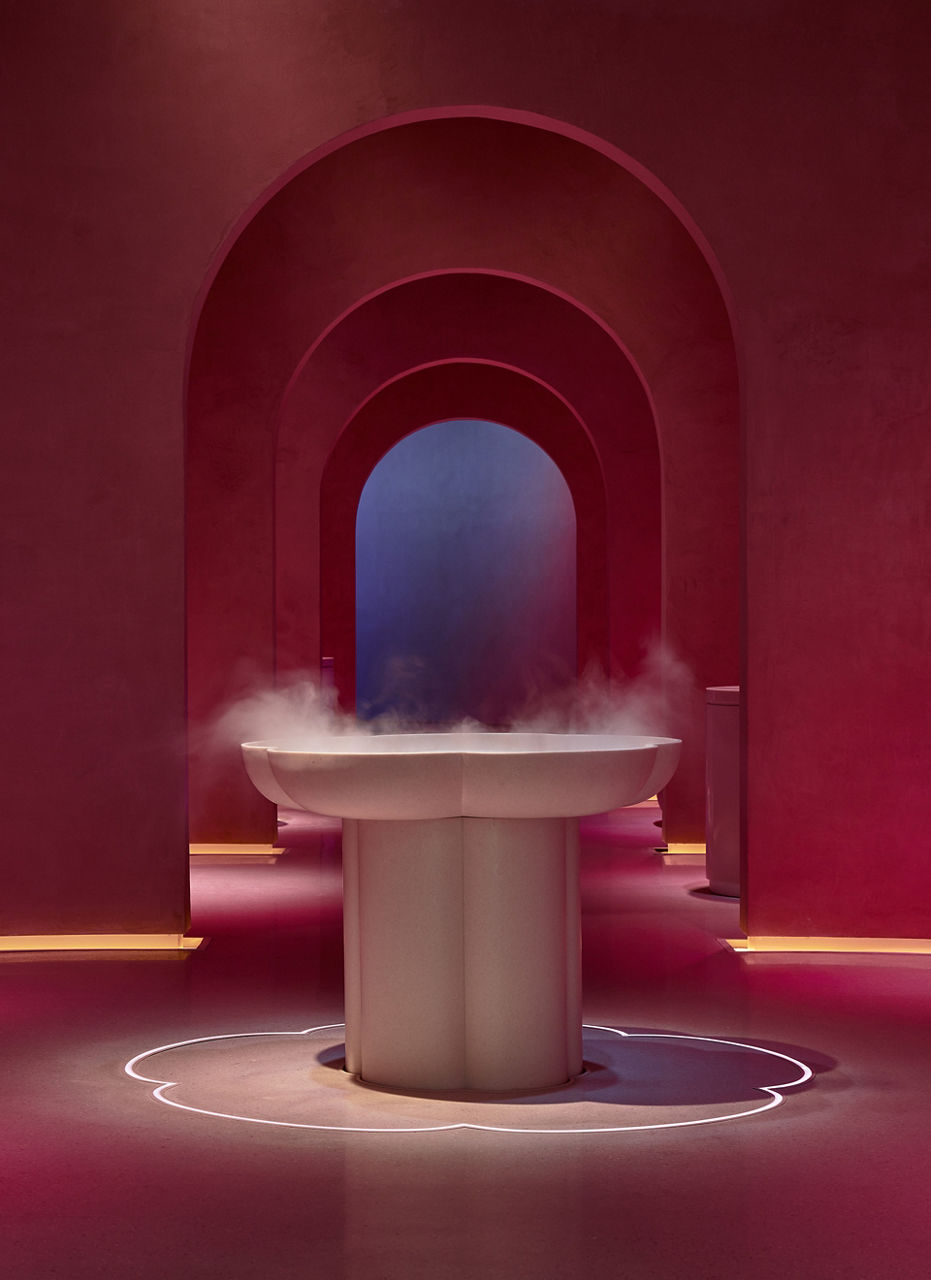 A view inside the spa with vapour pouring from a fountain.