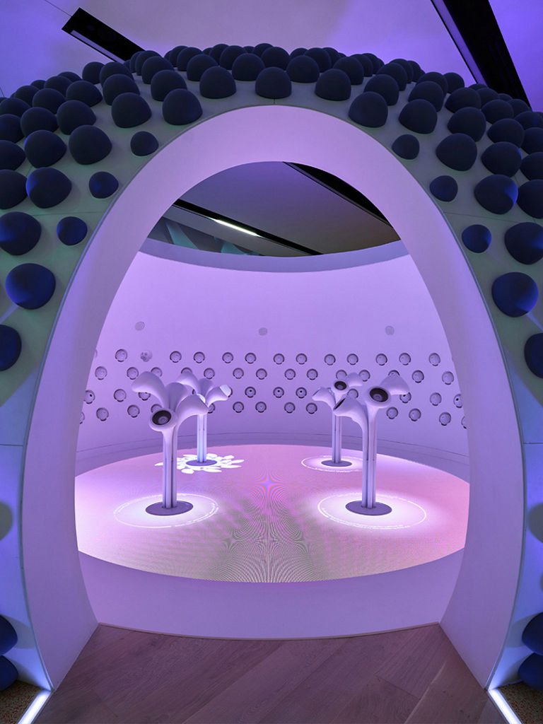 A view of a purple and pink booth designed for children to learn through play.