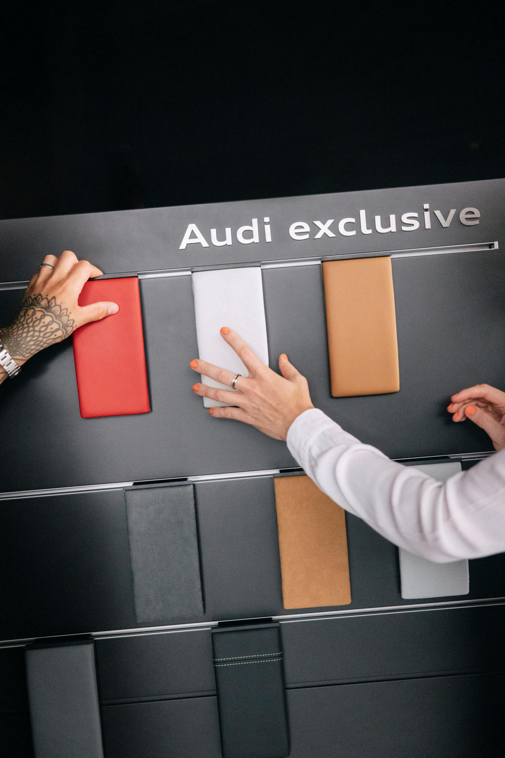 Both reach for samples on a display.